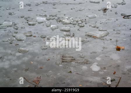 frozen ice surface on a lake with ice floes Stock Photo