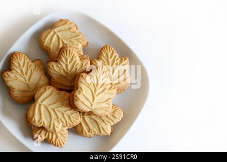 Classic Canadian maple leaf shaped cookies. Maple cream sandwiched between two crunchy cookies isolated on white background. Copy space. Stock Photo