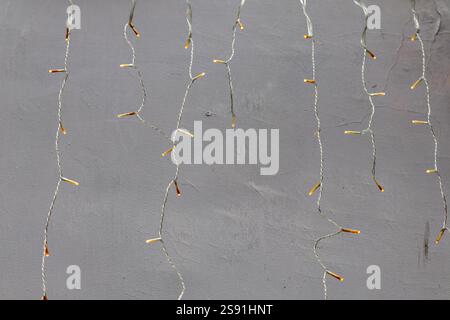 Yellow string lights that hang from a fixture, creating a cozy, festive atmosphere. Stock Photo