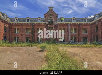 Exterior of abandoned brick buildings with overgrown fields Stock Photo ...