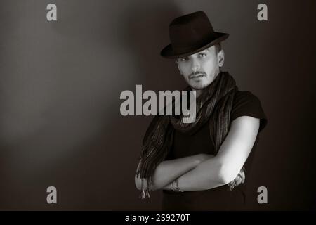 Handsome young man posing with hat, monochrome Stock Photo