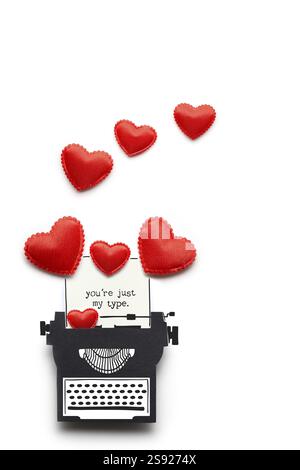 Creative valentines concept photo of a paper typewriter with hearts on a white background Stock Photo