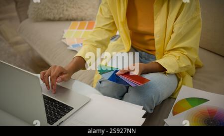 Unrecognizable woman businesswoman graphic designer architect hold multicolored palette catalog samples of rainbow colors wall paint choose color new Stock Photo