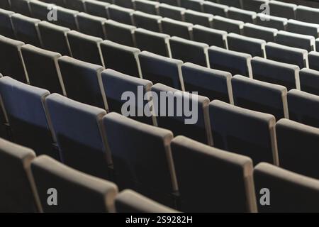 A minimalist composition featuring rows of empty theater seats. The clean lines and muted tones create a sense of calm and order. High quality photo Stock Photo