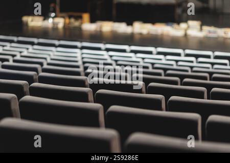 A minimalist composition featuring rows of empty theater seats. The clean lines and muted tones create a sense of calm and order. High quality photo Stock Photo