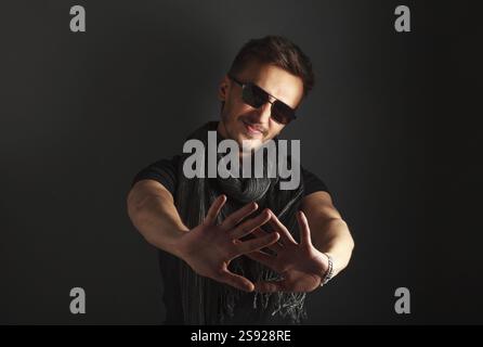 Portrait of a handsome man wearing sunglasses, unobtrusive image Stock Photo