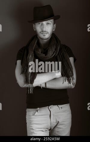 Handsome young man posing with hat, monochrome Stock Photo