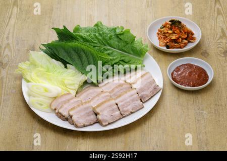 Bossam (sliced boiled pork belly wrapped with leaf vegetables ), Korean cuisine Stock Photo