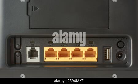 ports and connections of back of black internet router, telephone, ethernet or LAN and WLAN ports for connecting wired devices, power and usb ports Stock Photo