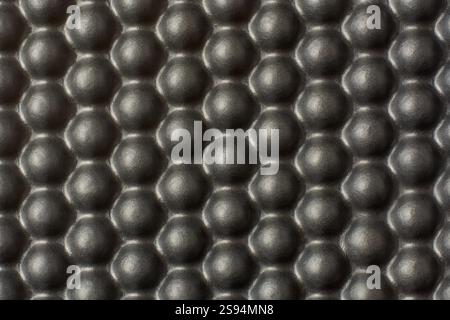 close-up view of sole of shoe pattern, abstract of black rubber texture, repeating hexagonal shapes surface of footwear for grip, full frame macro Stock Photo