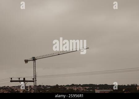 Construction Crane Against Overcast Sky Stock Photo