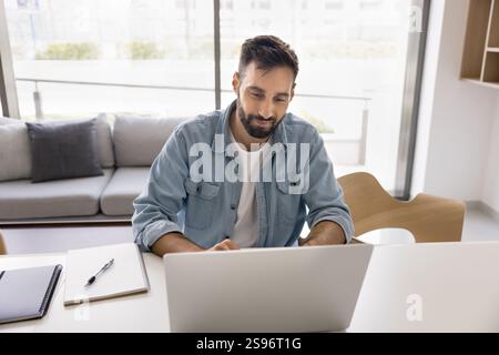 Handsome businessman read email, check correspondence using laptop Stock Photo