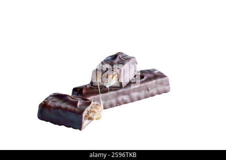 Two candy bars made of peanuts and caramel over a layer of nougat, with a chocolate coating. One product is broken in half to reveal inside. Isolated Stock Photo