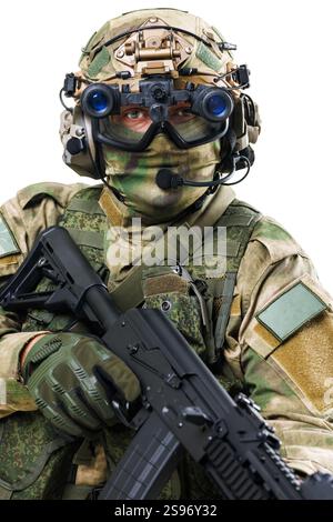 A soldier dressed in advanced tactical military gear holding a rifle ...