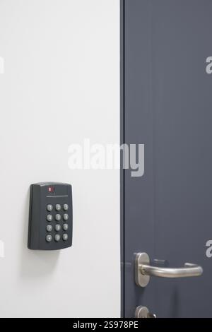 Security Panel and Door Handle on Modern Door Stock Photo