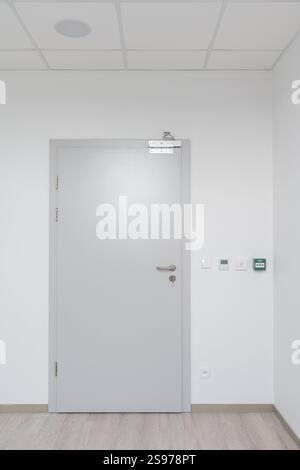 Modern White Door with Magnetic Lock and Control Panels Stock Photo