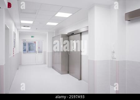 Modern Hospital Hallway with Stainless Steel Door and Exit Sign Stock Photo