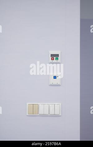 Electrical outlets on a white wall. Electrical cord plugged into a ...