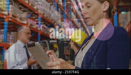 Image of data processing and diagrams over caucasian businesswoman using tablet in warehouse Stock Photo