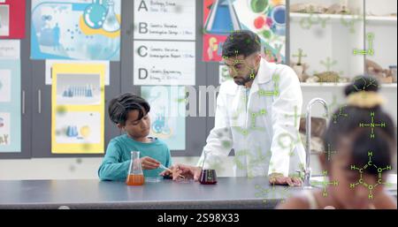 Chemistry teacher and student conducting experiment, chemical formulas over classroom scene Stock Photo