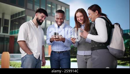 University Friends Outside Campus Using Smartphones Or Cellphones Stock Photo