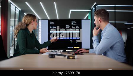 Accountant Checking Invoice For Online Payment On Computer Stock Photo