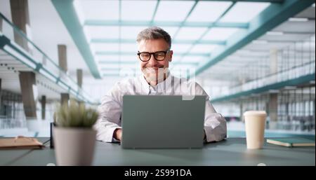 Successful Businessman Leading Team In Analyzing Market Trends And Utilizing Technology In Modern Office Setting Stock Photo