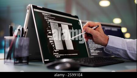 Programmer Or Coder At Office Desk Using Laptop Stock Photo