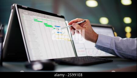 Project Management Software And Business Plan Schedule In Office Stock Photo