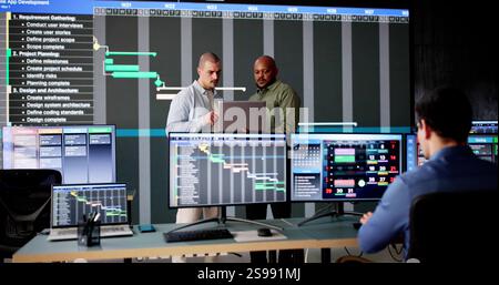 Multiracial Man Using Gantt Software to Schedule Virtual Meetings Stock Photo