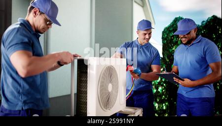 Industrial Air Conditioning Technician repairing black HVAC unit outside. Stock Photo