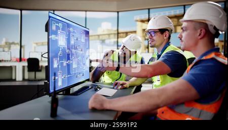 Young Male Engineer Operating Scada System at Shipping Port Terminal. Stock Photo
