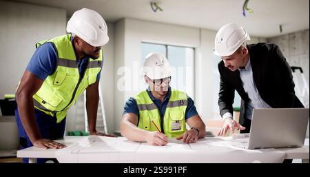 Skilled engineer and businessman collaborate on apartment construction project together. Stock Photo