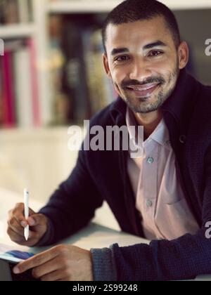 Portrait, graphic designer and businessman in office with tablet, artwork and editing layout for web. Night, male person and multimedia director with Stock Photo