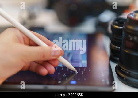 Graphic designer photo editing equipment digital tablet screen photo adjustment camera lens table creative freelance mobile studio space Stock Photo