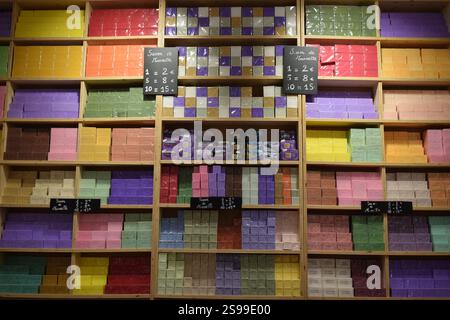 This vibrant image captures a beautifully organized display of traditional "Savon de Marseille" soaps in a French boutique. Stock Photo