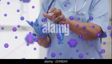 Medical professional putting on gloves, surrounded by healthcare icons image Stock Photo