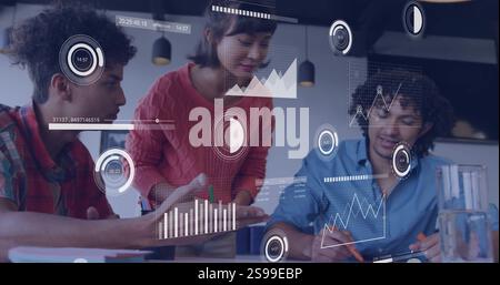 Analyzing data charts and graphs image over diverse business team collaborating Stock Photo
