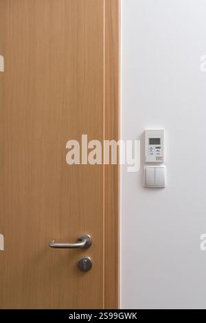 Modern Interior with Wooden Door and Control Panel Stock Photo