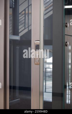 Close-up of Modern Elevator Control Panel and Glass Door Stock Photo