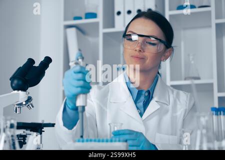 A dedicated scientist is conducting groundbreaking research in a stateoftheart lab, focusing on biotechnology, chemistry, and genetics to advance our Stock Photo