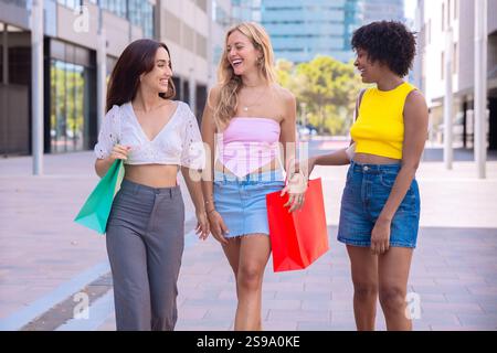 Three Happy Women Shopping and Strolling Outdoors. Stock Photo