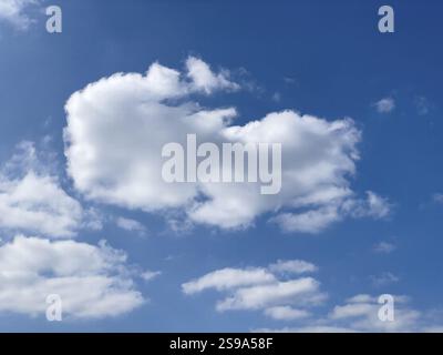 Altocumulus white clouds in front of blue sky, international Stock Photo