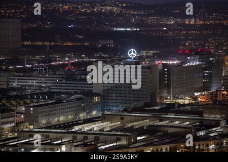 High-rise buildings overlook an illuminated street and a construction ...