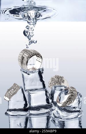 A look at jewellery falling onto ice cubes under water Stock Photo