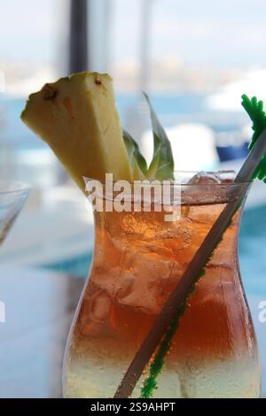 Close-Up of Tropical Drink Garnished with Pineapple Slice Stock Photo