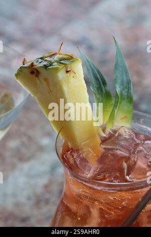 Close-Up of Tropical Drink Garnished with Pineapple Slice Stock Photo