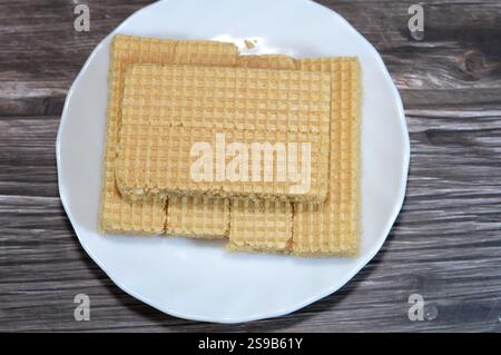 layers of wafer biscuits filled with creamy vanilla, a wafer is a crisp, sweet, very thin, flat, light biscuit,  creamy vanilla sandwiched in wafers, Stock Photo