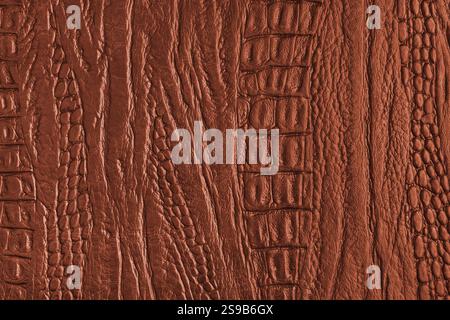 Crocodile genuine leather structure texture macro, orange colored leatherette surface with metallic, pearlescent effect. Reptile skin close up, macro Stock Photo