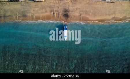 Idyllic beach in Indonesia with moored boats, seen from above Stock Photo